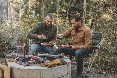 Kodiak Food Service Resources - founder Joel Clark and Cameron Smith toast some waffles under a camp fire