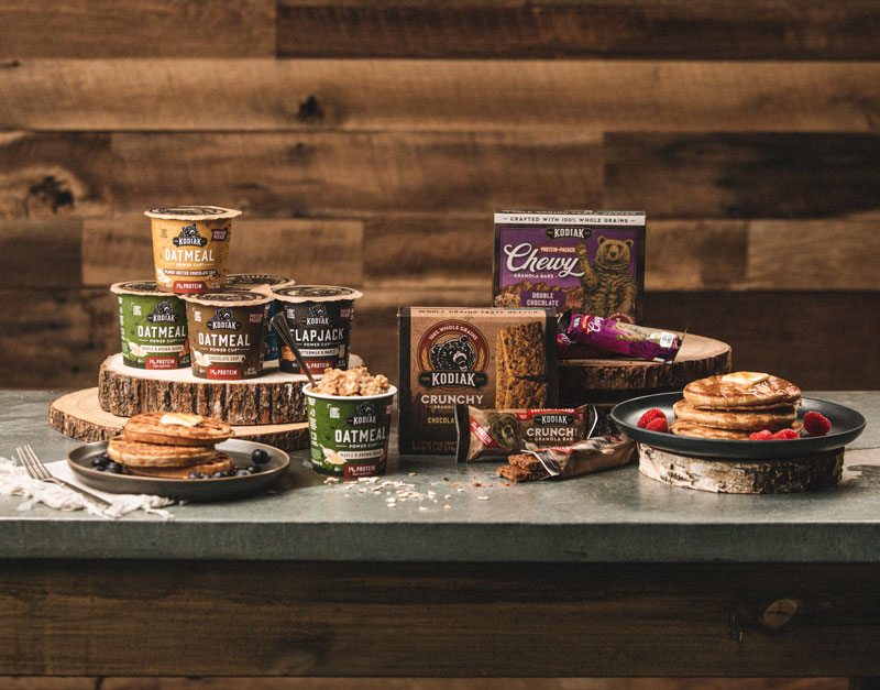 food service channels - kodiak cakes on the go products sit on a kitchen table with pancakes and fresh fruit